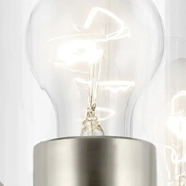 The Crosby vanity light combines brushed nickel finish with clear glass shades for a timeless look. Its 23-inch width makes it ideal for medium to large vanities, while dimmable functionality and damp rating ensure versatility. - alternate view