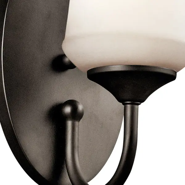 The Aubrey Wall Sconce combines traditional styling with practical functionality. Its compact 10.75" height and satin etched opal glass shade provide soft, diffused lighting perfect for hallways and bathrooms. - alternate view