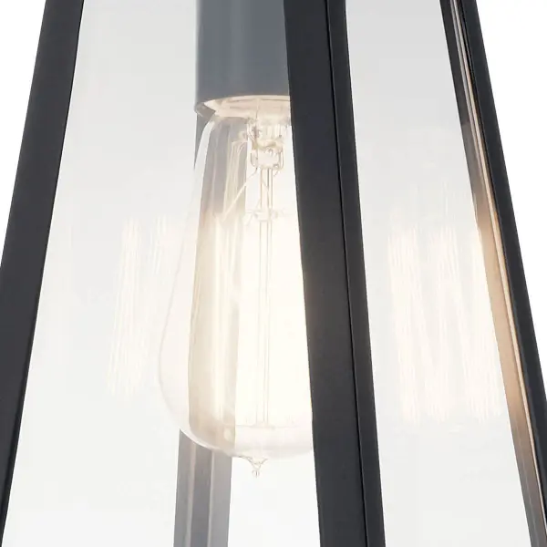 The Delison outdoor wall light combines timeless design with practical functionality. Its clear glass shade and black finish create a versatile look that complements various architectural styles while providing reliable illumination. - alternate view