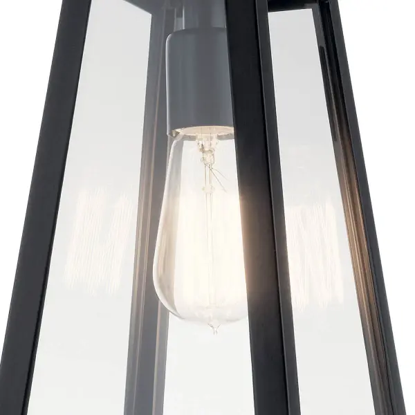 The Delison outdoor wall light combines timeless design with practical functionality. Its clear glass shade and black finish create a versatile look that complements various architectural styles while providing reliable illumination. - alternate view