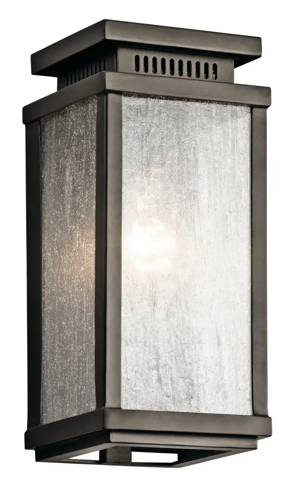 The Manningham outdoor wall sconce delivers traditional charm with practical durability. Its clear seeded glass and Olde Bronze finish create authentic colonial character, while wet-rated construction ensures reliable performance in exposed locations.