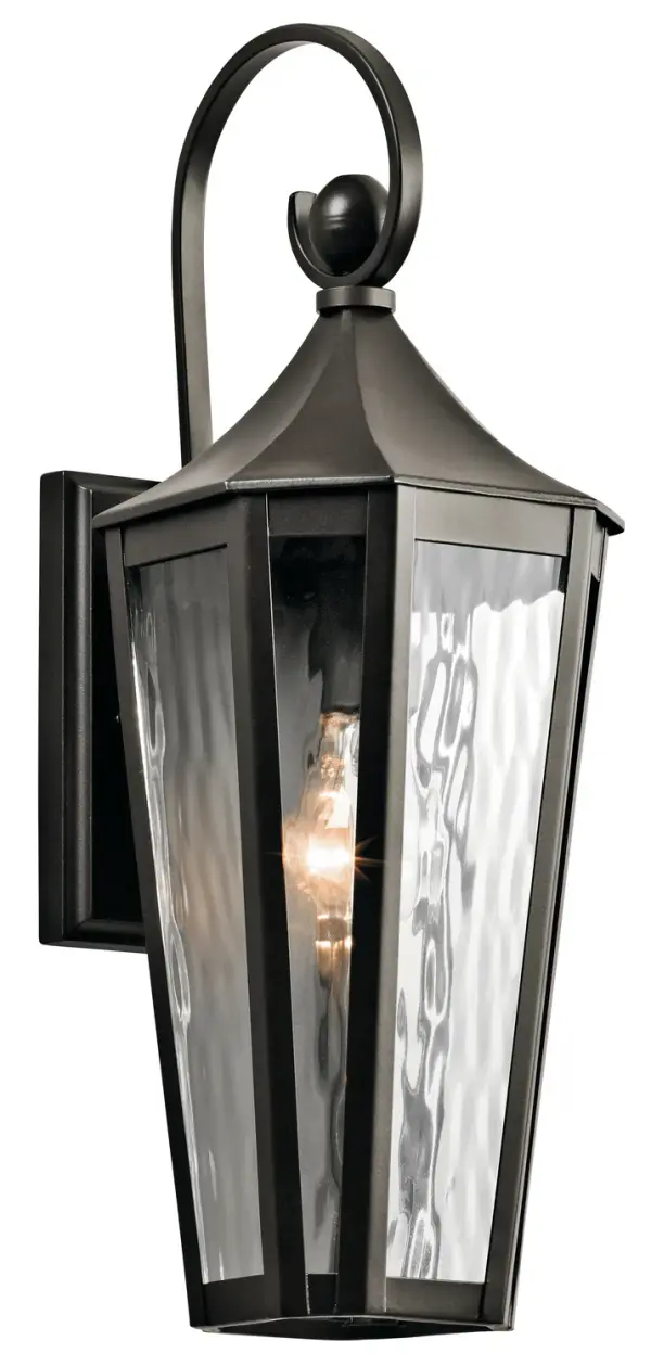 The Rochdale outdoor wall sconce blends traditional styling with clean, elongated lines. Its wet-rated aluminum construction and textured water glass create visual interest while providing reliable outdoor illumination.