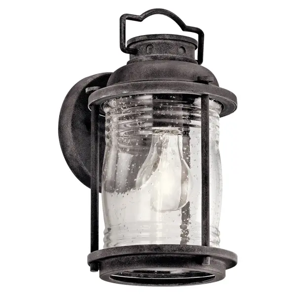 The Ashland Bay brings nautical charm to outdoor spaces with its weathered zinc finish and clear seeded glass. Compact at 11" tall, it's perfect for flanking doors or illuminating pathways with wet-rated durability.