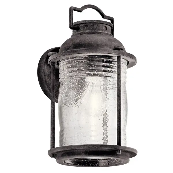 The Ashland Bay brings nautical charm to outdoor spaces with its weathered zinc finish and clear seeded glass. Perfect for coastal and transitional homes, this dimmable fixture combines durability with timeless style.