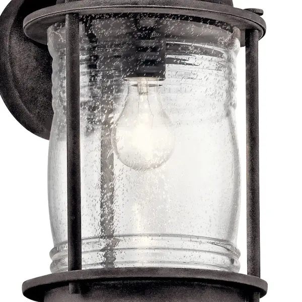 The Ashland Bay brings timeless nautical elegance to outdoor spaces with its weathered zinc finish and clear seeded glass. Wet-rated for harsh conditions, this compact wall light delivers reliable illumination with dimmable control. - alternate view