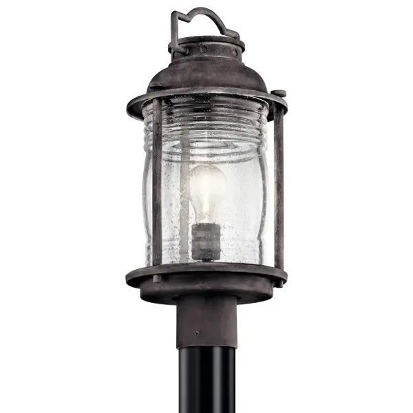 The Ashland Bay brings timeless nautical charm to outdoor spaces with its weathered zinc finish and clear seeded glass. Wet-rated for durability, this compact post light delivers reliable illumination with traditional styling. - alternate view