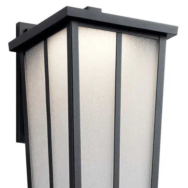 The Amber Valley combines transitional styling with modern LED efficiency. Its textured black finish and seeded glass create ambient lighting perfect for entryways and outdoor living spaces. Wet-rated for all weather conditions. - alternate view