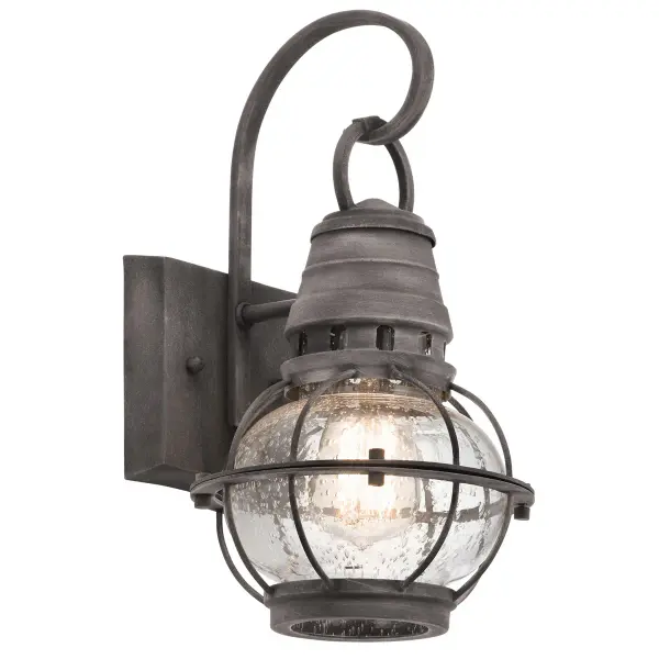 The Bridge Point Outdoor Wall Light combines farmhouse style with industrial durability. Its weathered zinc finish and clear seeded glass create authentic character while wet-rated construction ensures reliable performance.