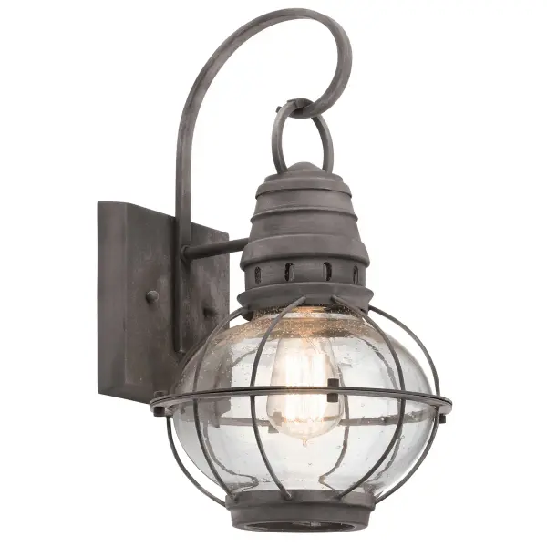 The Bridge Point Outdoor Wall Light combines transitional styling with practical outdoor performance. Its weathered zinc finish and clear seeded glass create authentic coastal character while wet-rated construction ensures reliable illumination.