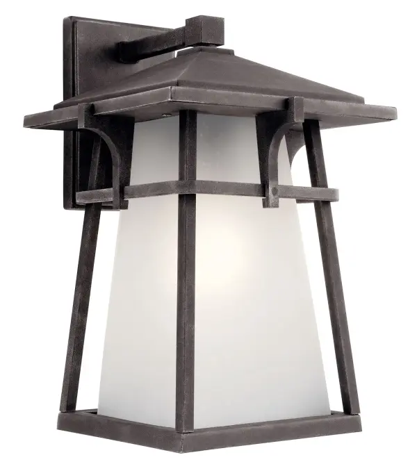 The Beckett Outdoor Wall Light combines transitional style with durable wet-rated construction. Its weathered zinc finish and seeded glass shade create visual interest while providing reliable outdoor illumination.