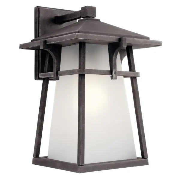 The Beckett outdoor wall light combines industrial style with transitional appeal. Its weathered zinc finish and satin etched seeded glass create visual interest while providing reliable outdoor illumination.