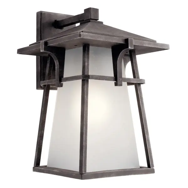The Beckett Outdoor Wall Light combines transitional styling with industrial charm, featuring weathered zinc finish and seeded glass. Wet-rated for all weather conditions with dimmable LED/Halogen compatibility.