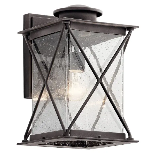 The Argyle Outdoor Wall Light combines weathered zinc finish with clear seeded glass for authentic farmhouse appeal. Wet-rated and dimmable, it delivers reliable performance in any weather while adding character to entryways and patios.