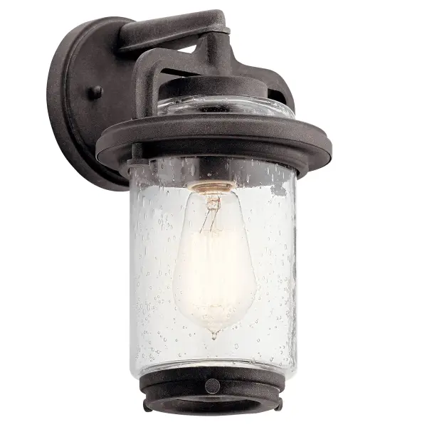 The Andover brings rustic charm to outdoor spaces with its weathered zinc finish and clear seeded glass. This compact 1-light fixture offers wet-rated durability and dimmable functionality, perfect for creating welcoming entryways.