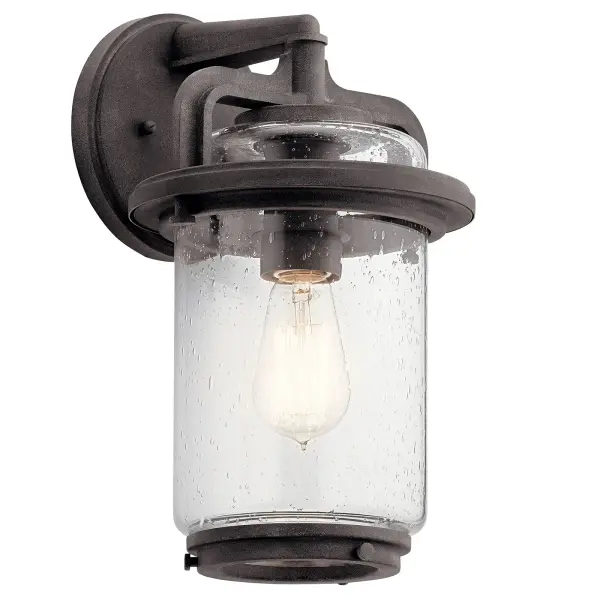 The Andover outdoor wall light combines rustic weathered zinc finish with clear seeded glass for authentic farmhouse appeal. Wet-rated for all weather conditions and dimmable for ambiance control.