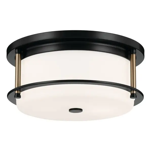 The Brit flush mount combines sleek black and champagne bronze finishes with soft opal glass for a sophisticated modern look. Its compact 12-inch diameter makes it ideal for smaller spaces requiring stylish overhead lighting.
