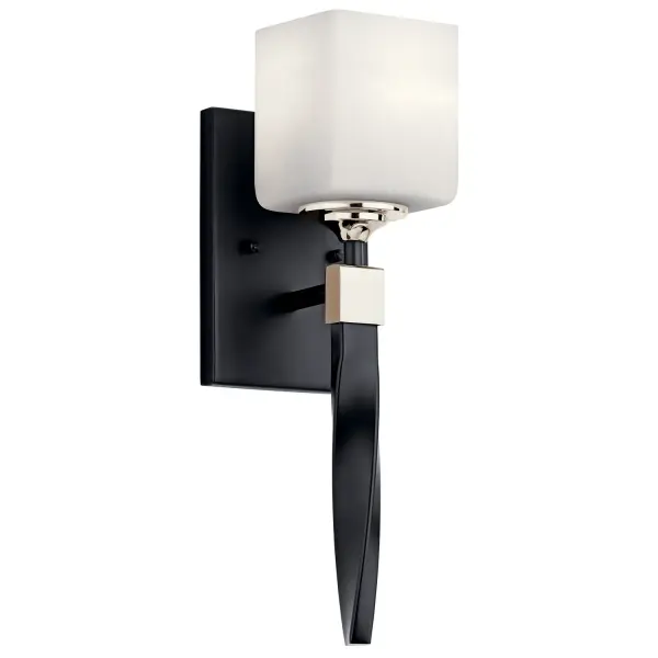 The Marette wall sconce combines a twisted arm detail with satin etched opal glass for soft, diffused light. Its compact 5-inch width and transitional design make it adaptable across traditional, transitional, and modern interiors.