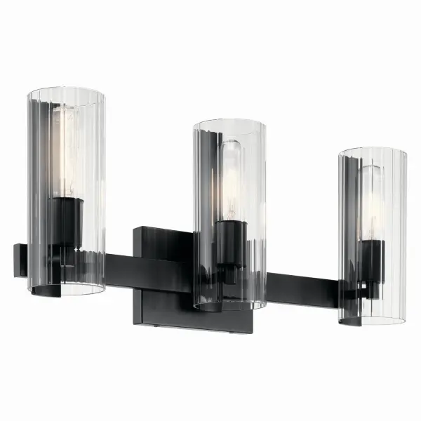 The Jemsa vanity light brings contemporary elegance to bathroom spaces with its distinctive clear fluted glass shades and refined black finish. The three-light configuration provides ample illumination for grooming tasks while the sophisticated glass treatment adds visual interest and modern grandeur.