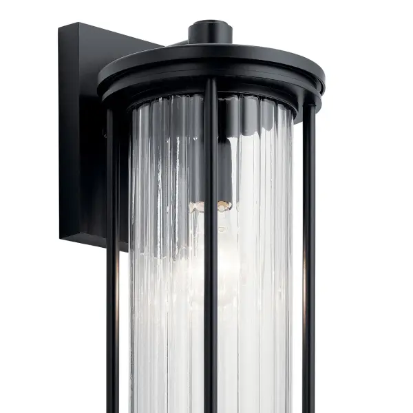 The Barras outdoor wall light combines contemporary design with practical outdoor lighting. Its dark sky compliant design minimizes light pollution while the clear ribbed glass adds visual texture and interest. - alternate view