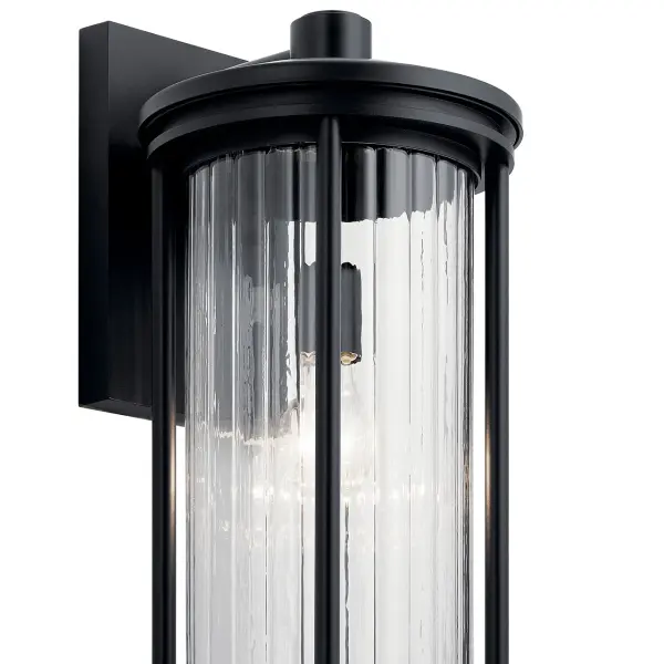 The Barras outdoor wall light combines modern design with environmental responsibility. Its Dark Sky compliant design minimizes light pollution while the clear ribbed glass creates beautiful light patterns. Wet-rated for durability. - alternate view