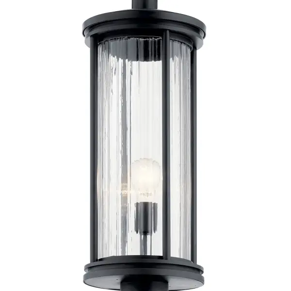 The Barras outdoor post light combines timeless design with durable wet-rated construction. Its clear ribbed glass shade and black finish create elegant curb appeal while providing reliable illumination for pathways and entryways. - alternate view