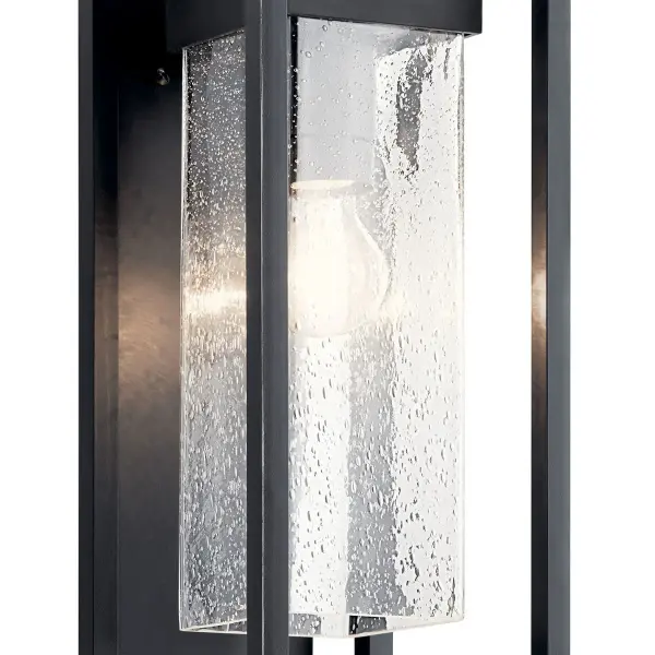 The Mercer Outdoor Wall Light combines transitional styling with industrial accents, featuring clear seeded glass and a black finish with silver highlights. Wet-rated and dimmable for versatile outdoor use. - alternate view