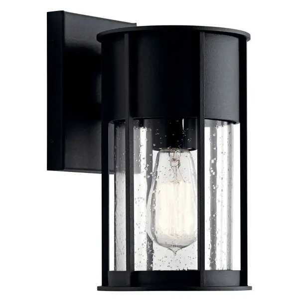 The Camillo brings timeless appeal to outdoor spaces with its textured black finish and clear seeded glass. Wet-rated for durability and dimmable for ambiance control, this compact fixture suits various architectural styles.