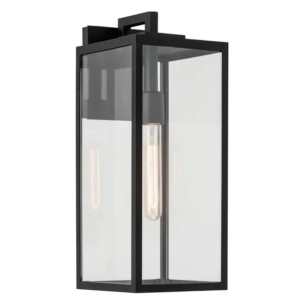 The Branner outdoor wall light combines transitional styling with industrial touches, featuring a textured black finish and clear glass shade. Wet-rated for full weather exposure, this medium-sized fixture works beautifully on porches, patios, and entryways.