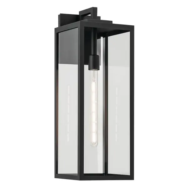 The Branner Outdoor Wall Light combines transitional styling with industrial elements, featuring a textured black finish and clear glass shade. Wet-rated for maximum weather protection, this 24-inch fixture delivers reliable illumination.