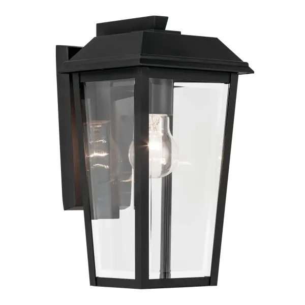 The Mathus outdoor wall sconce combines durability with refined style through its textured black aluminum frame and thick beveled glass panes. Wet-rated for all weather conditions, it delivers reliable illumination with classic appeal.