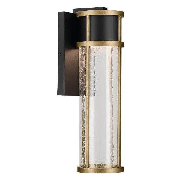 The Camillo combines contemporary design with industrial elements, featuring textured black finish with natural brass accents and clear seeded glass. Wet-rated and energy-efficient with integrated LED, perfect for modern outdoor spaces.