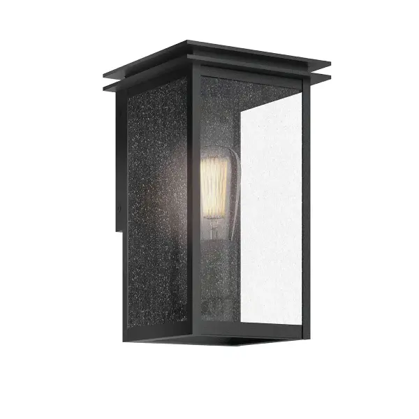 The Arkville outdoor wall light combines rustic farmhouse charm with practical outdoor durability. Its black textured finish and seeded glass shade create warm, inviting illumination perfect for entryways and porches.