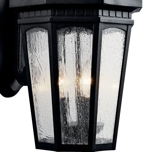 The Courtyard 3-Light Outdoor Wall Light combines traditional styling with durable wet-rated construction. Its textured black finish and clear seeded glass create welcoming illumination for entryways and outdoor living spaces. - alternate view