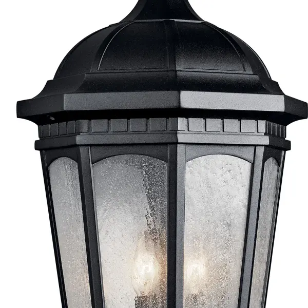 The Courtyard 3-Light Outdoor Hanging Light combines traditional design with durable outdoor construction. Its textured black finish and clear seeded glass create warm, inviting illumination for covered outdoor spaces. - alternate view