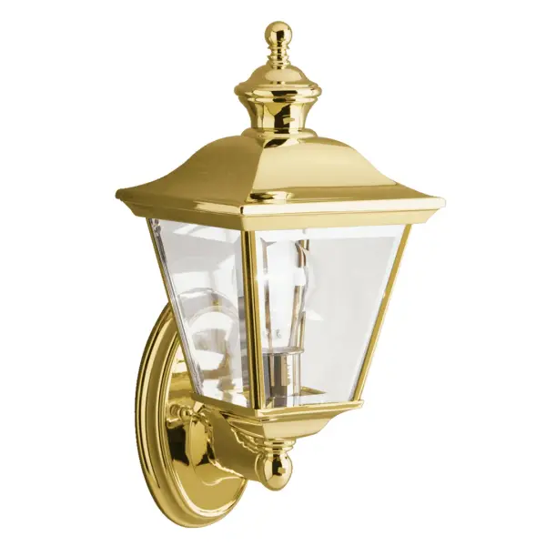 The Bay Shore Outdoor Wall Light combines traditional craftsmanship with weather-resistant durability. Its polished brass finish and clear beveled glass create elegant illumination for entryways and outdoor living spaces.