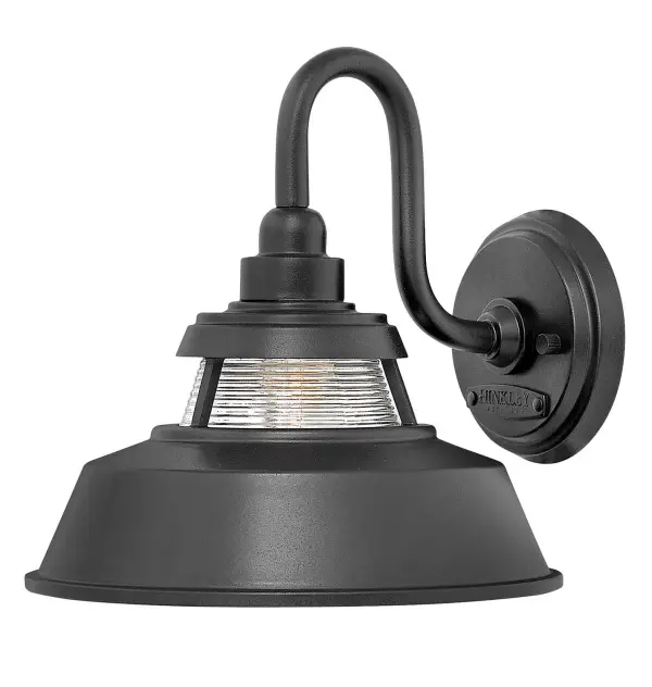 The Troyer LED Wall Sconce delivers authentic American farmhouse style with energy-efficient LED technology. Its solid aluminum construction and unique ribbed glass accent create warm, inviting illumination perfect for outdoor spaces.