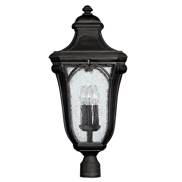 The Trafalgar post lantern brings historical elegance to outdoor spaces with its cast aluminum construction, delicate scroll arch details, and authentic distressed Museum Black finish. Clear seedy glass adds vintage charm while LED technology provides modern efficiency.