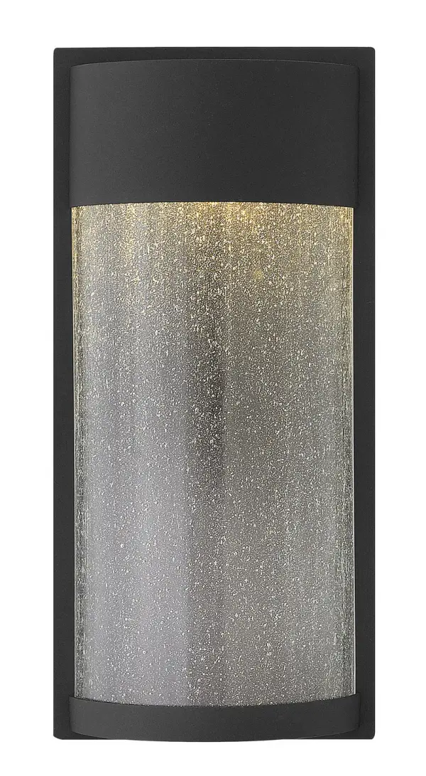 The Shelter LED wall sconce delivers minimalist modern style with functional outdoor lighting. Its aluminum construction and clear seedy glass create visual interest while the integrated LED provides efficient, long-lasting illumination.