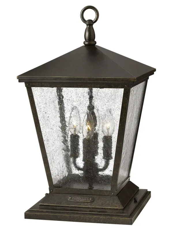 The Trellis LED Pier Mount brings Old World elegance to outdoor spaces with its scrolled arms, cast loop finial, and authentic rivet details. The Regency Bronze finish paired with clear seedy glass creates warm ambiance while LED technology provides energy-efficient illumination. Wet-rated for durability in all weather conditions.