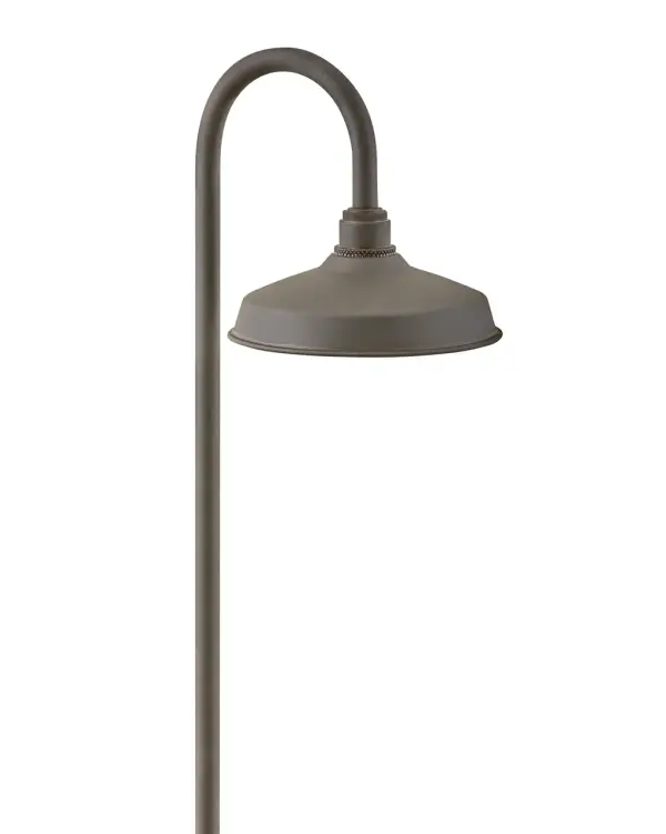 The Foundry LED Path Light combines industrial aesthetics with modern LED efficiency. Its sturdy aluminum shade with knurled brass details creates focused, uniform illumination perfect for pathways and outdoor spaces.