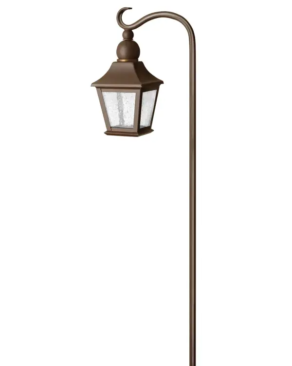 The Bratenahl path light combines traditional craftsmanship with modern LED efficiency. Its copper bronze finish and seedy glass panels create warm, inviting illumination perfect for pathways and garden borders.