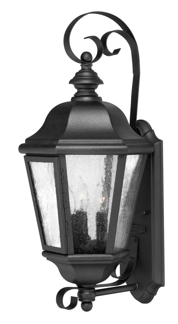 The Edgewater LED wall sconce combines timeless lantern styling with modern LED technology. Its cast aluminum and brass construction ensures durability in outdoor conditions, while the clear seedy glass adds vintage charm.