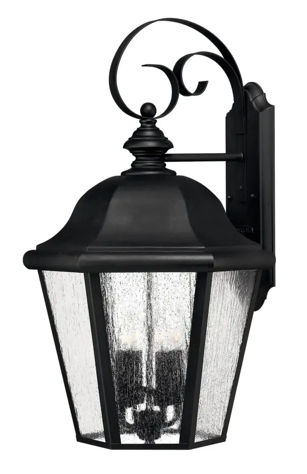 The Edgewater LED wall lantern combines timeless design with modern LED efficiency. Its cast aluminum and brass construction ensures durability in outdoor conditions, while the clear seedy glass adds vintage character.