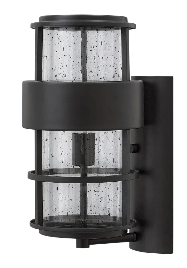 The Saturn LED Wall Mount combines bold intersecting lines with clear seedy glass for a contemporary outdoor lighting statement. Wet-rated aluminum construction ensures durability, while integrated LED provides energy-efficient illumination.