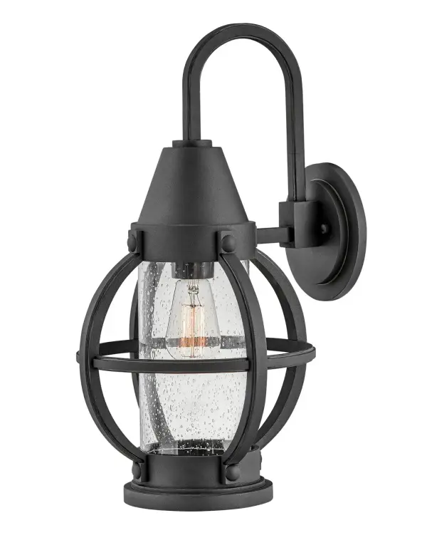 The Chatham LED Wall Lantern combines traditional onion-style design with contemporary LED technology. Its seedy glass and refined scroll arm create coastal elegance, while the rust-resistant Museum Black finish ensures durability in harsh weather.