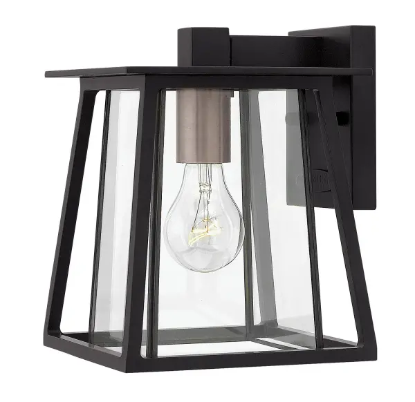 The Walker LED Wall Mount combines rugged American West aesthetics with modern minimalism. Its two-tone aluminum and brass construction features strong angular lines and a clear bound glass shade, creating a versatile fixture that works equally well on ranch homes, mountain cabins, or mid-century modern exteriors.