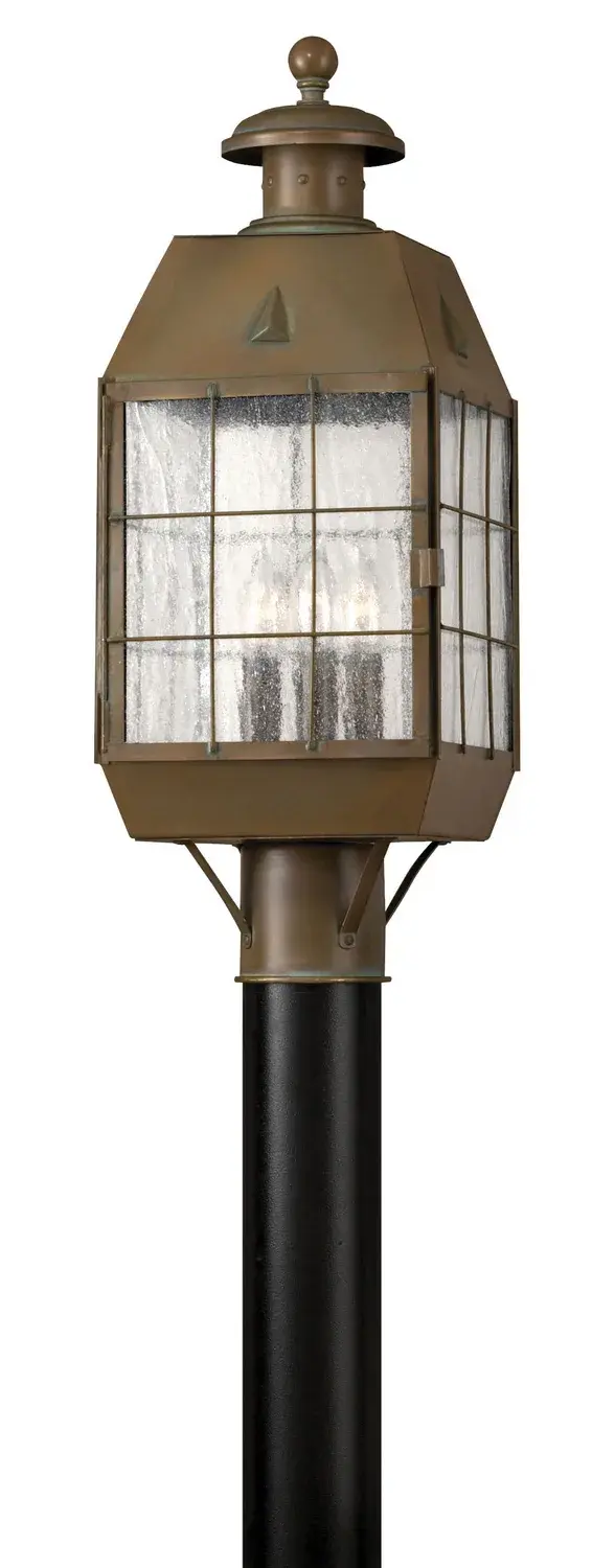The Nantucket post lantern delivers timeless coastal elegance with solid brass construction and vintage seedy glass. LED technology provides energy-efficient illumination while maintaining authentic period character.