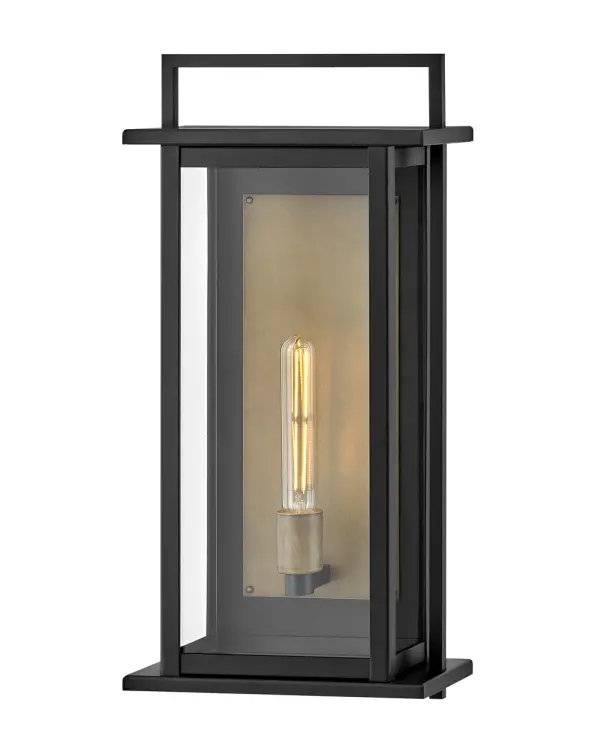 The Langston LED Wall Mount combines dramatic scale with modern efficiency. Its bold black silhouette and extra-large clear glass panes create a stunning light beam, while the burnished bronze reflector adds warmth.
