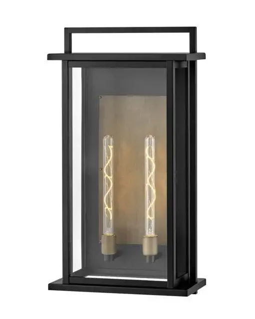 The Langston LED Wall Mount makes a dramatic statement with its oversized 28-inch height and bold black finish. The extra-large clear glass panes and burnished bronze reflector create stunning light projection, perfect for grand entryways and commercial facades.
