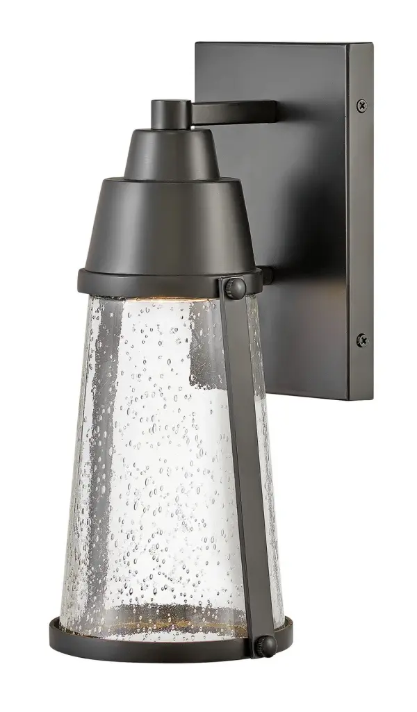 The Miles LED wall mount combines transitional design with coastal influences, featuring a layered cap detail and clear seedy glass. Wet-rated for true outdoor use with an energy-efficient LED bulb included.
